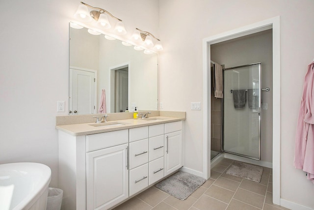 2990 Stoke Way, Ann Arbor, MI 48105 - bathroom with double vanity, tile patterned floors, a stall shower, and baseboards