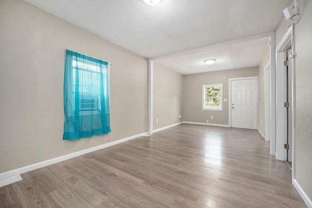 64 E Grand Circle Ave, Battle Creek, MI 49037 - empty room with wood finished floors, a textured ceiling, and baseboards