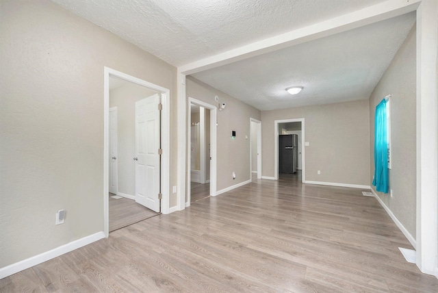 64 E Grand Circle Ave, Battle Creek, MI 49037 - unfurnished room featuring a textured ceiling, light wood finished floors, and baseboards