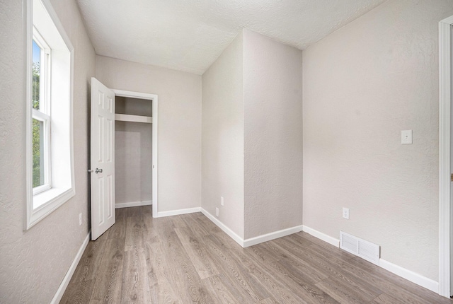 64 E Grand Circle Ave, Battle Creek, MI 49037 - unfurnished bedroom featuring light wood-type flooring, baseboards, and a closet