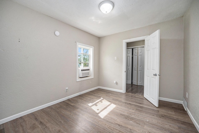 64 E Grand Circle Ave, Battle Creek, MI 49037 - unfurnished bedroom with wood finished floors, baseboards, and cooling unit