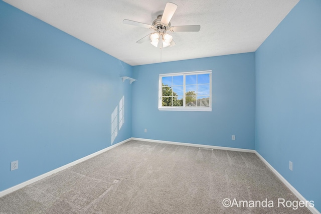 648 Firestone Dr SE, Byron Center, MI 49315 - carpeted empty room with ceiling fan, baseboards, and a textured ceiling