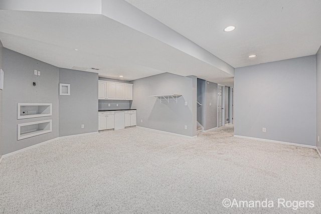 648 Firestone Dr SE, Byron Center, MI 49315 - unfurnished living room featuring baseboards, light carpet, built in features, and recessed lighting