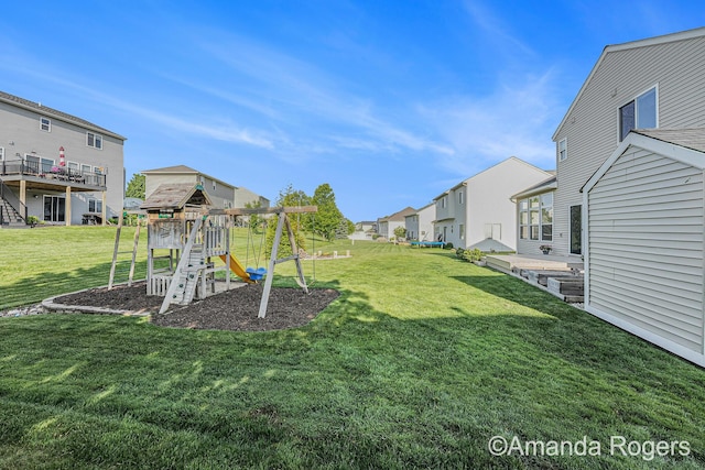 648 Firestone Dr SE, Byron Center, MI 49315 - view of grassy yard featuring a residential view and a playground