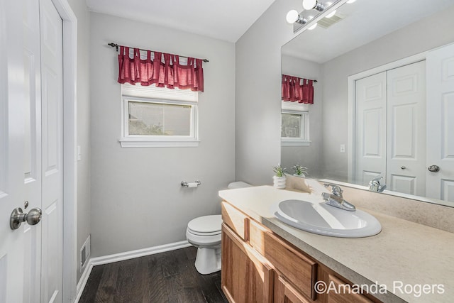 648 Firestone Dr SE, Byron Center, MI 49315 - bathroom with wood finished floors, vanity, baseboards, and toilet