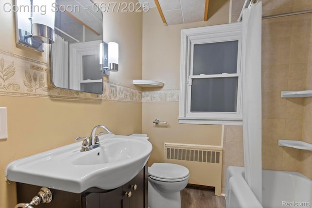 114 Interlochen Dr, Algonac, MI 48001 - bathroom featuring radiator, toilet, vanity, wood finished floors, and shower / tub combo with curtain