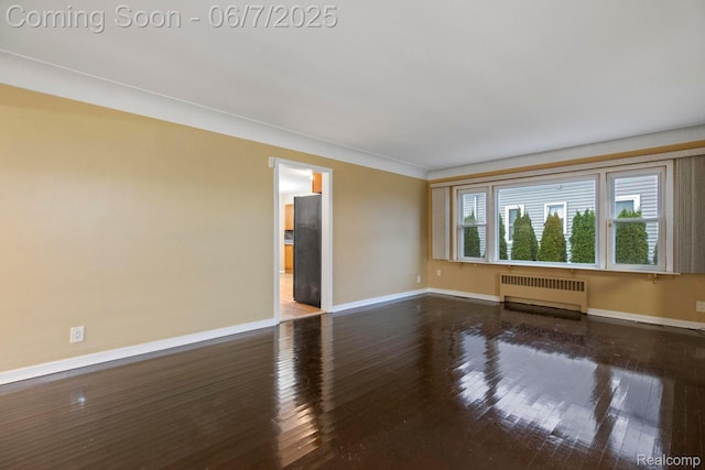 114 Interlochen Dr, Algonac, MI 48001 - spare room featuring radiator, baseboards, and wood-type flooring