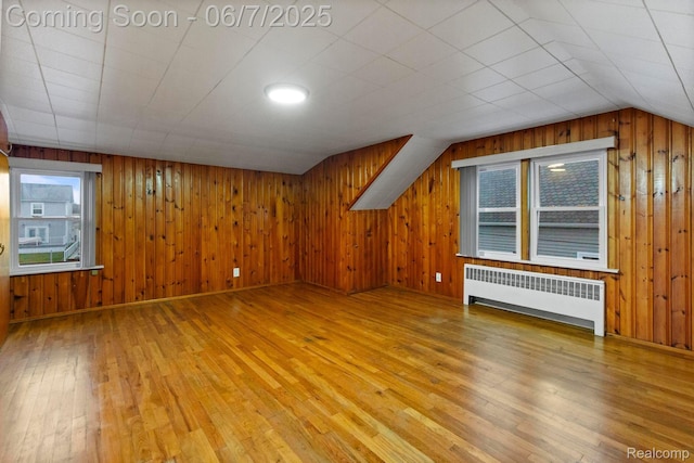 114 Interlochen Dr, Algonac, MI 48001 - bonus room featuring radiator heating unit, hardwood / wood-style flooring, wooden walls, and lofted ceiling