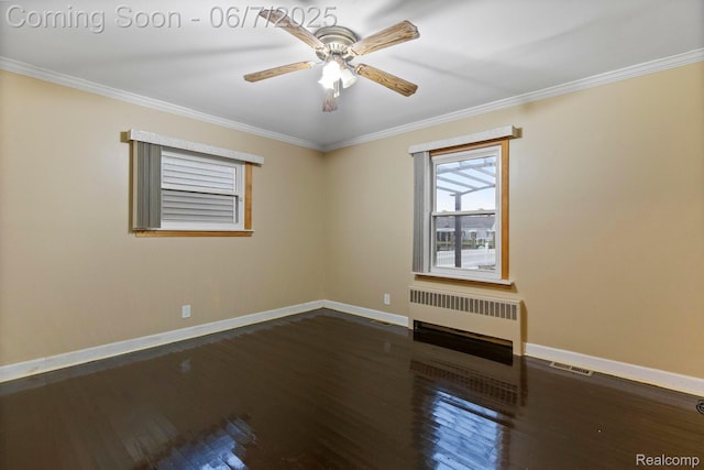 114 Interlochen Dr, Algonac, MI 48001 - unfurnished room with radiator, baseboards, ornamental molding, a ceiling fan, and dark wood-style flooring