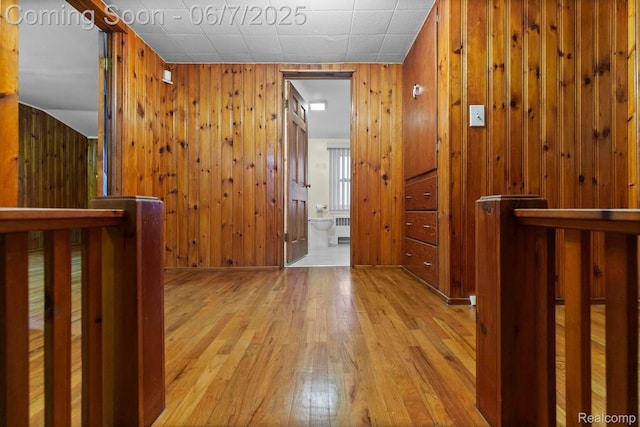 114 Interlochen Dr, Algonac, MI 48001 - corridor featuring radiator, wood-type flooring, and wood walls