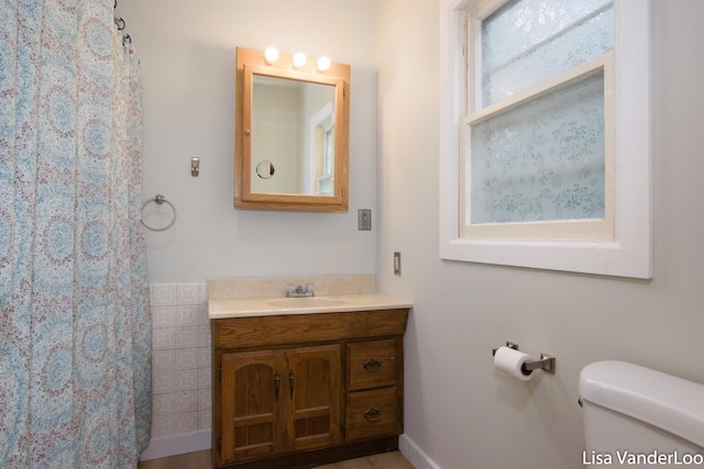 1819 Willis Ave NW, Grand Rapids, MI 49504 - bathroom featuring vanity, toilet, and a shower with shower curtain