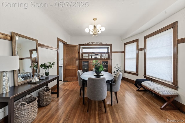 5302 Burns St, Detroit, MI 48213 - dining room featuring a chandelier, wood finished floors, and baseboards