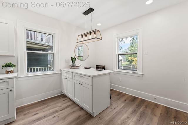 5302 Burns St, Detroit, MI 48213 - kitchen featuring light wood finished floors, baseboards, recessed lighting, light countertops, and decorative light fixtures