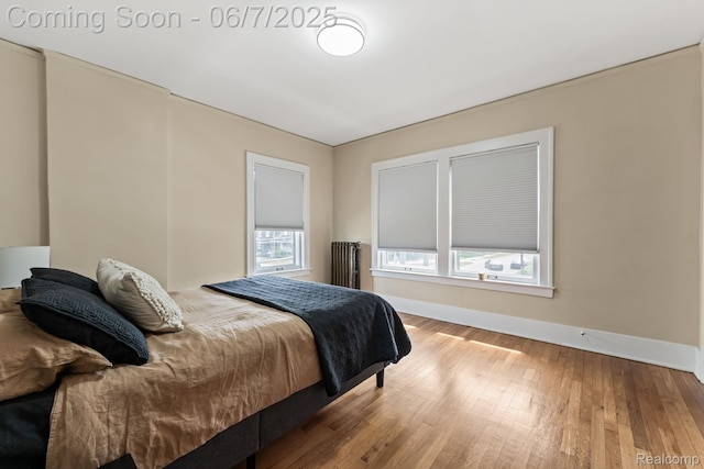 5302 Burns St, Detroit, MI 48213 - bedroom featuring baseboards, wood-type flooring, and radiator heating unit