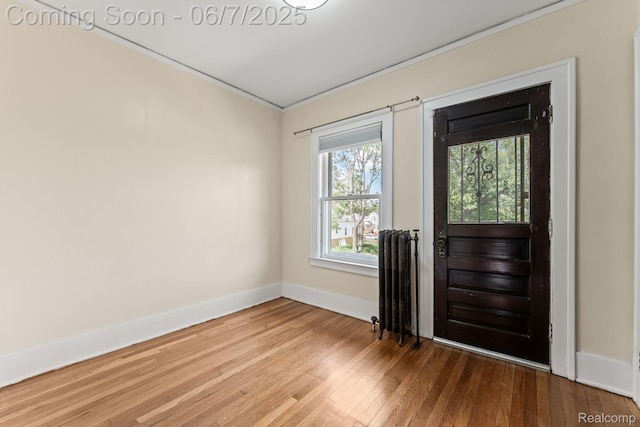 5302 Burns St, Detroit, MI 48213 - entrance foyer with baseboards, ornamental molding, hardwood / wood-style flooring, and radiator heating unit
