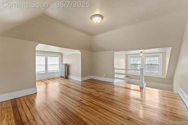 5302 Burns St, Detroit, MI 48213 - unfurnished living room featuring lofted ceiling, wood-type flooring, and baseboards