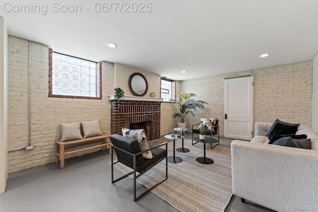 5302 Burns St, Detroit, MI 48213 - living room featuring brick wall, finished concrete floors, a fireplace, and recessed lighting