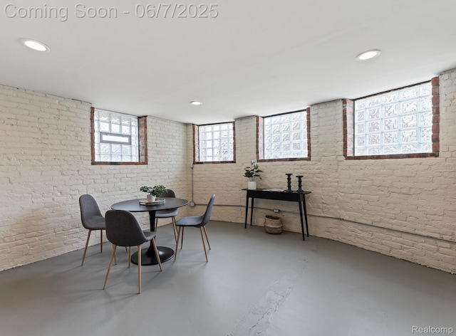 5302 Burns St, Detroit, MI 48213 - dining space featuring concrete floors, brick wall, and recessed lighting