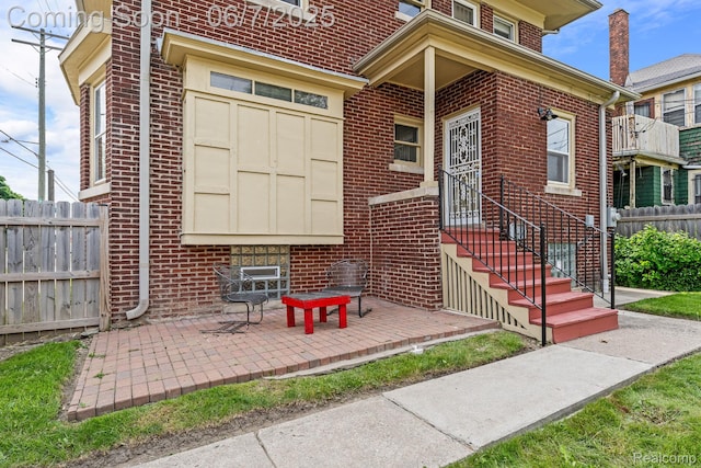 5302 Burns St, Detroit, MI 48213 - property entrance with brick siding and a patio area