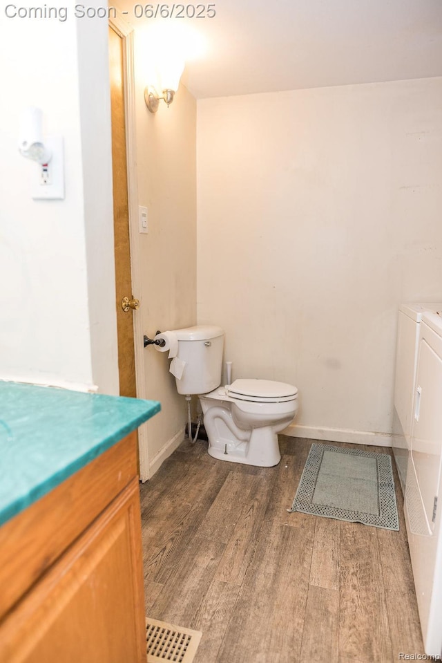 923 Stone St, Port Huron, MI 48060 - bathroom featuring toilet, wood finished floors, vanity, and baseboards
