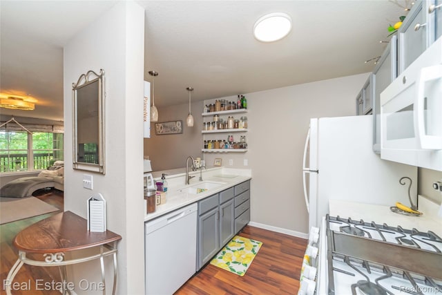 12267 Saint Andrews Way, Fenton, MI 48430 - kitchen featuring a sink, white appliances, dark wood-style floors, gray cabinetry, and light countertops