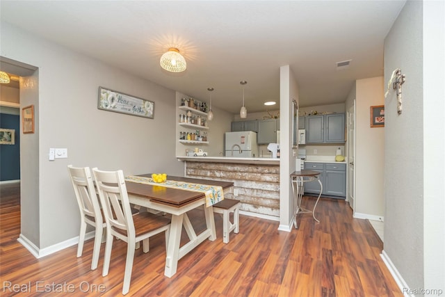 12267 Saint Andrews Way, Fenton, MI 48430 - dining area featuring dark wood-style floors and baseboards