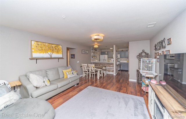 12267 Saint Andrews Way, Fenton, MI 48430 - living area featuring wood finished floors and baseboards