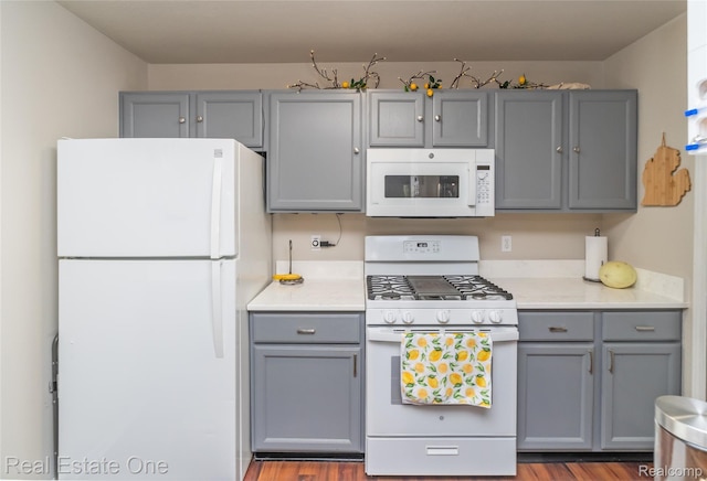 12267 Saint Andrews Way, Fenton, MI 48430 - kitchen with white appliances, gray cabinetry, light countertops, and wood finished floors