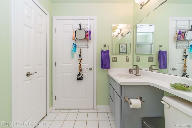 12267 Saint Andrews Way, Fenton, MI 48430 - bathroom with toilet, vanity, tile patterned flooring, a closet, and baseboards
