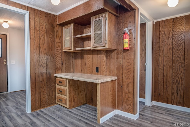5730 Cavendar Dr, Mount Pleasant, MI 48883 - kitchen with wood finished floors, brown cabinetry, light countertops, wooden walls, and open shelves