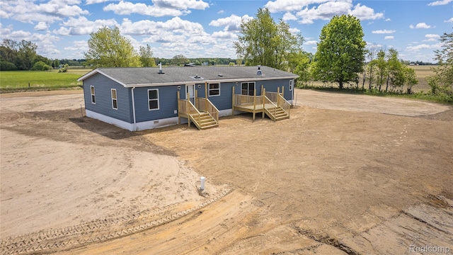 5730 Cavendar Dr, Mount Pleasant, MI 48883 - back of property featuring crawl space, roof with shingles, and driveway