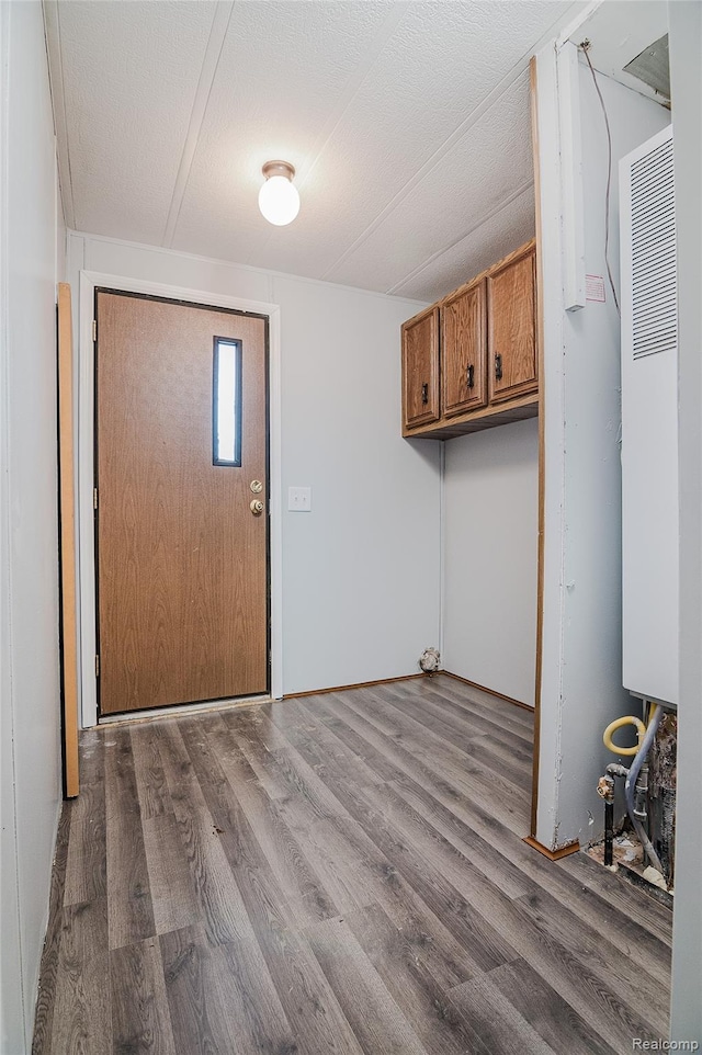 5730 Cavendar Dr, Mount Pleasant, MI 48883 - laundry area with wood finished floors and a heating unit