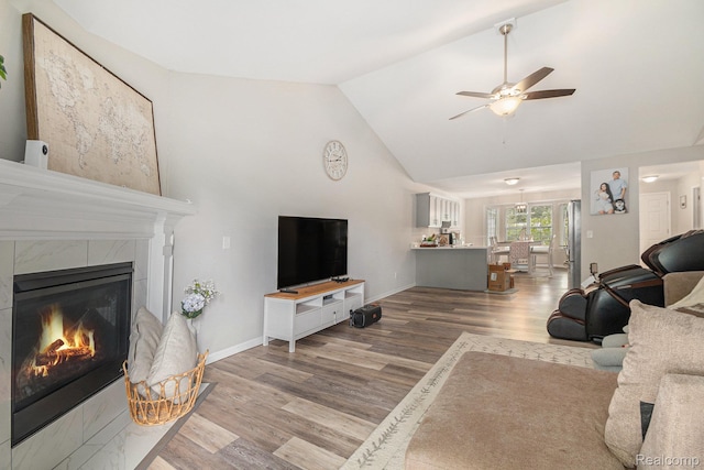 816 Nelsons Ridge Dr, Howell, MI 48843 - living room featuring a fireplace, wood finished floors, a ceiling fan, high vaulted ceiling, and baseboards