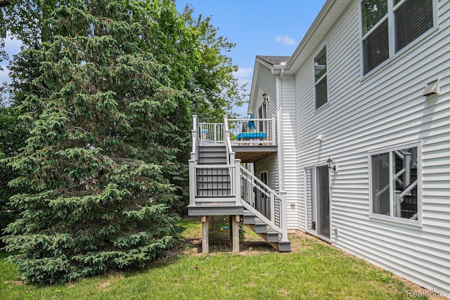 816 Nelsons Ridge Dr, Howell, MI 48843 - rear view of house featuring stairway, a deck, and a lawn