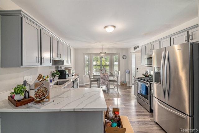 816 Nelsons Ridge Dr, Howell, MI 48843 - kitchen with appliances with stainless steel finishes, gray cabinets, wood finished floors, and a sink