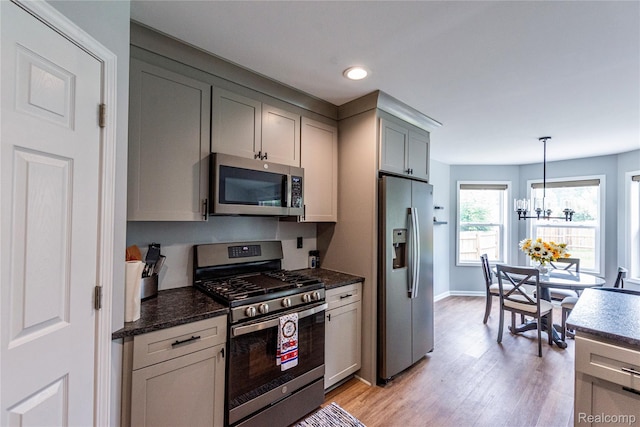 3982 Ontario Dr, Auburn Hills, MI 48326 - kitchen with stainless steel appliances, light wood finished floors, gray cabinets, recessed lighting, and dark stone counters