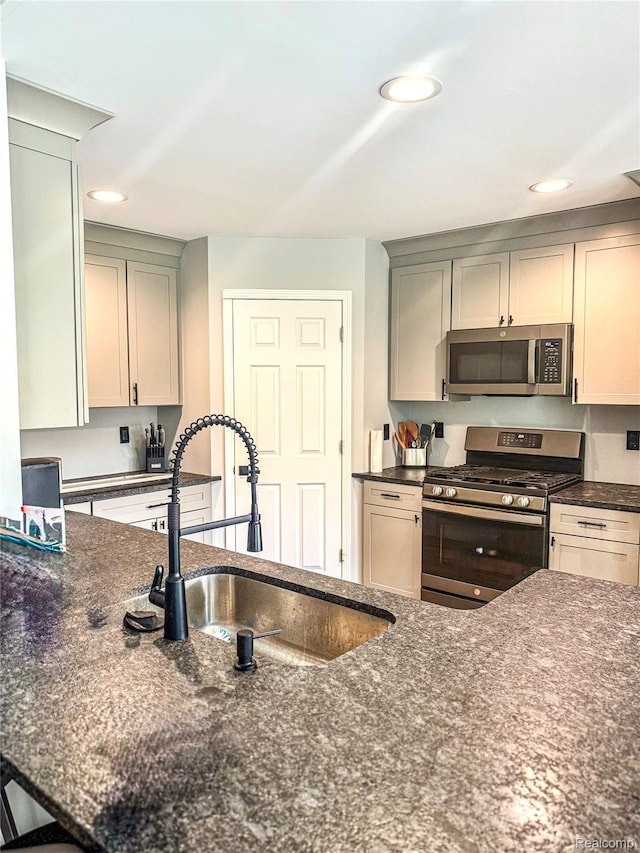 3982 Ontario Dr, Auburn Hills, MI 48326 - kitchen featuring stainless steel appliances, dark stone counters, and recessed lighting