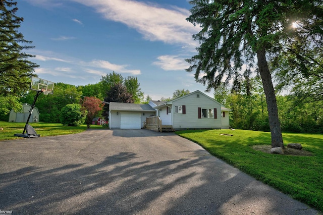2284 E Frances Rd, Clio, MI 48420 - view of front facade featuring asphalt driveway, an attached garage, and a front lawn