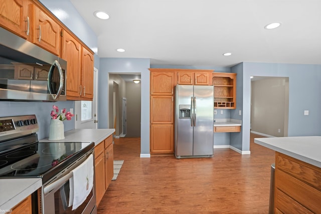 2284 E Frances Rd, Clio, MI 48420 - kitchen featuring appliances with stainless steel finishes, wood finished floors, light countertops, open shelves, and recessed lighting