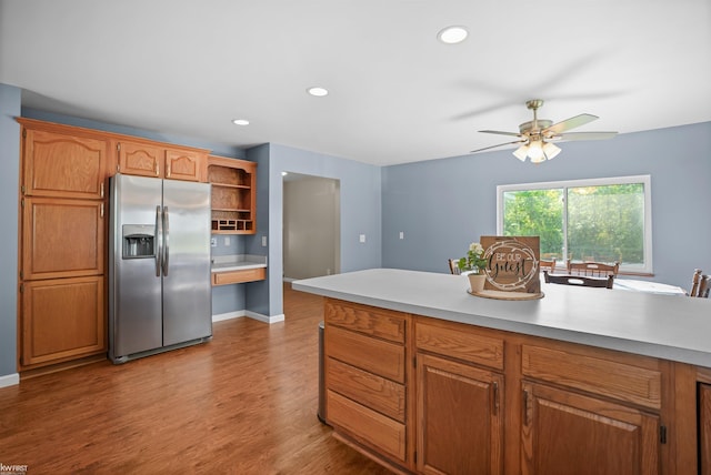 2284 E Frances Rd, Clio, MI 48420 - kitchen featuring stainless steel fridge with ice dispenser, open shelves, wood finished floors, light countertops, and recessed lighting