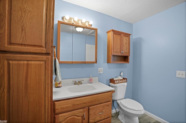 2284 E Frances Rd, Clio, MI 48420 - bathroom with vanity, toilet, and a textured ceiling