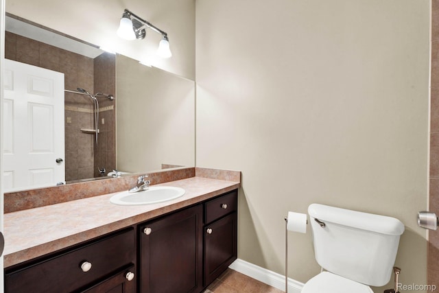48888 Amanda Ln, Shelby Twp, MI 48317 - bathroom with vanity, toilet, tiled shower, tile patterned flooring, and baseboards