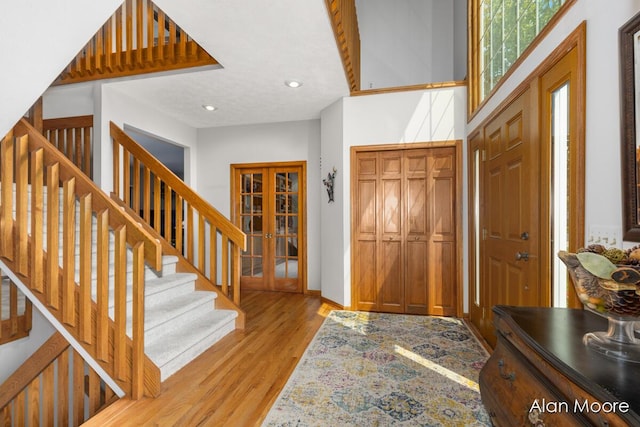 6574 Gran Via Dr NE, Rockford, MI 49341 - entrance foyer with light wood-type flooring, french doors, stairway, recessed lighting, and baseboards
