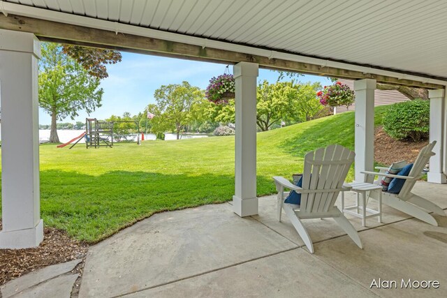 6574 Gran Via Dr NE, Rockford, MI 49341 - view of patio featuring a playground and a water view