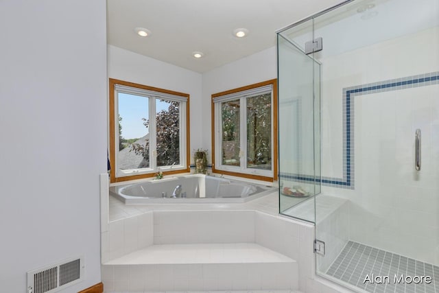 6574 Gran Via Dr NE, Rockford, MI 49341 - bathroom featuring a bath, a shower stall, and recessed lighting
