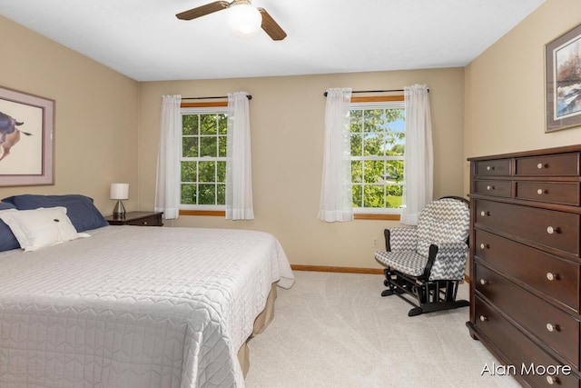 6574 Gran Via Dr NE, Rockford, MI 49341 - bedroom with light carpet, baseboards, and ceiling fan