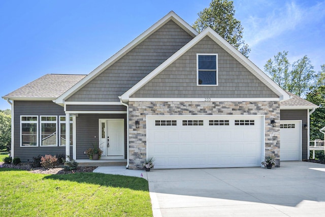 233 Markus Glen Dr, Plainwell, MI 49080 - craftsman-style house with an attached garage, driveway, a front lawn, and stone siding