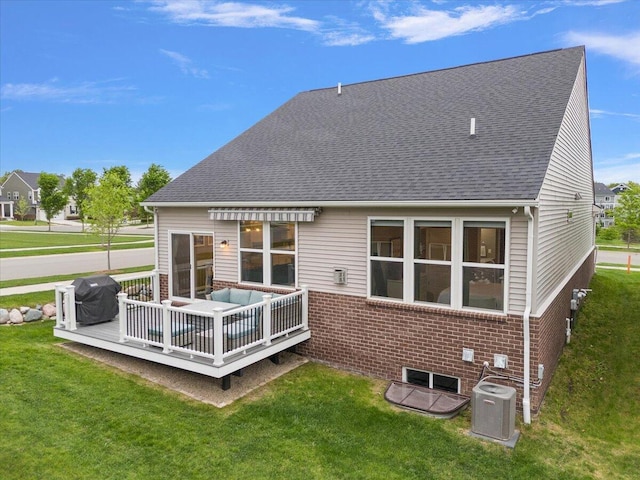 2765 Polson St, Ann Arbor, MI 48105 - back of property with central AC unit, brick siding, a deck, and a lawn