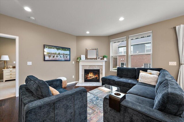 2765 Polson St, Ann Arbor, MI 48105 - living area with dark wood finished floors, a tile fireplace, recessed lighting, and baseboards