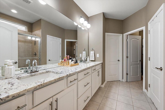 2765 Polson St, Ann Arbor, MI 48105 - full bath featuring double vanity, a shower stall, tile patterned floors, and baseboards